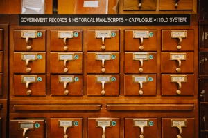 A close up photograph of an old wooden record keeping cabinet.